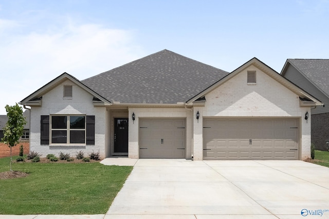 view of front of house featuring a front lawn and a garage