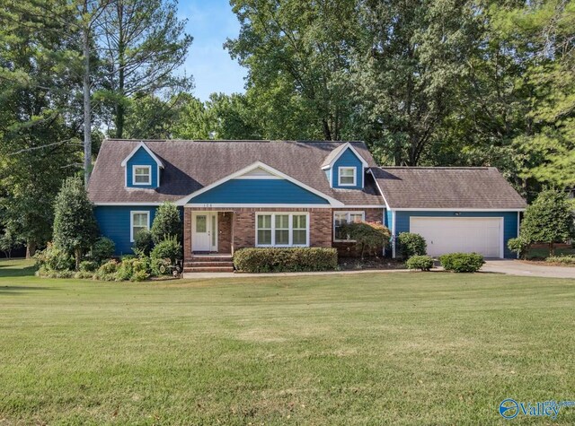 cape cod-style house featuring a front yard and a garage