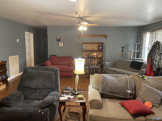 living room with ceiling fan and dark hardwood / wood-style flooring