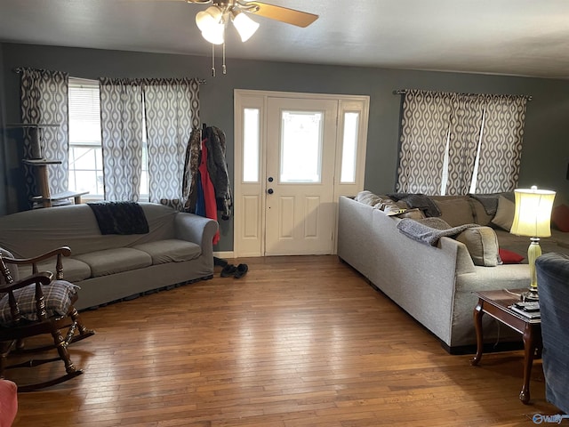 living room with wood-type flooring and ceiling fan