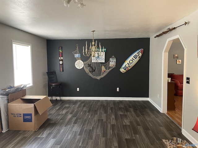 dining space with an inviting chandelier and dark hardwood / wood-style flooring