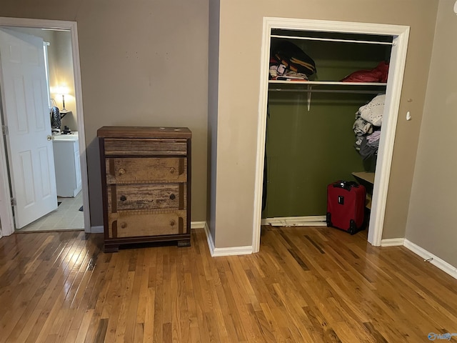 unfurnished bedroom featuring light hardwood / wood-style floors and a closet