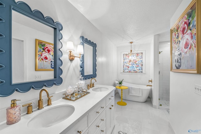 bathroom with vanity, tile patterned flooring, plus walk in shower, and a textured ceiling