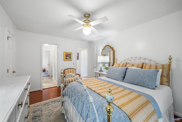 bedroom with dark hardwood / wood-style floors, connected bathroom, and ceiling fan