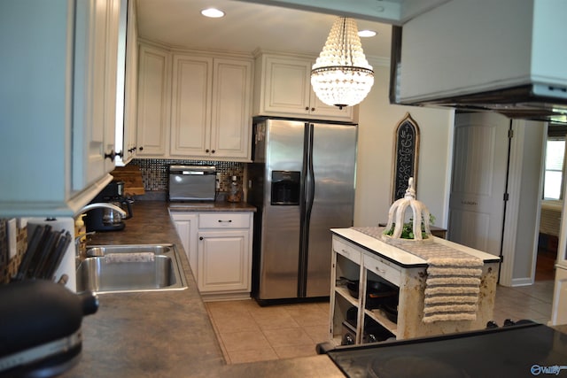 kitchen with stainless steel refrigerator with ice dispenser, decorative light fixtures, tasteful backsplash, sink, and light tile patterned flooring