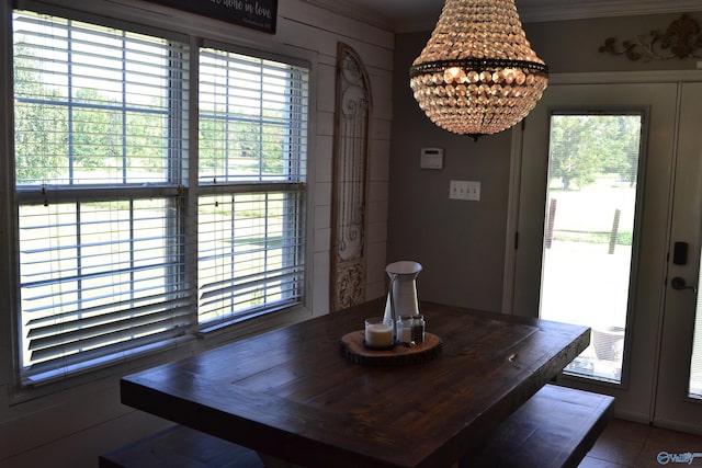 unfurnished dining area with a healthy amount of sunlight and an inviting chandelier