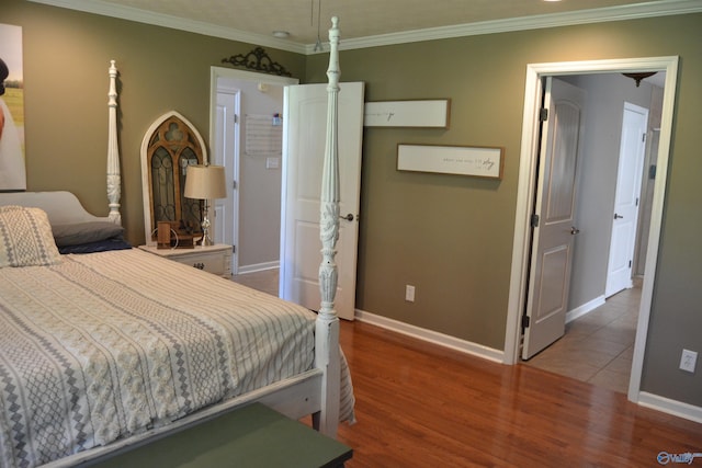 bedroom with crown molding and hardwood / wood-style flooring