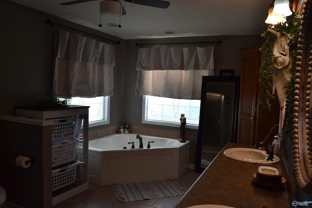 bathroom featuring vanity, a washtub, ceiling fan, and tile patterned floors