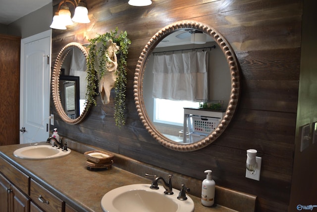 bathroom with walk in shower, vanity, and wooden walls