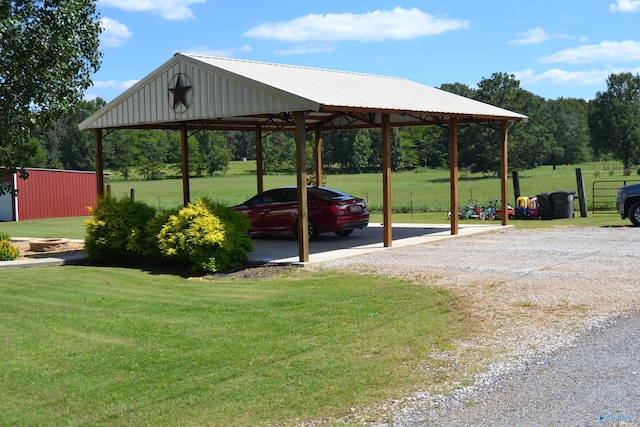 view of parking / parking lot featuring a lawn and a carport