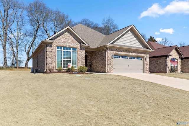 view of front of home with a garage, driveway, brick siding, and a front yard