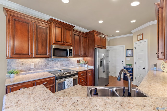 kitchen featuring light stone counters, crown molding, tasteful backsplash, appliances with stainless steel finishes, and a sink