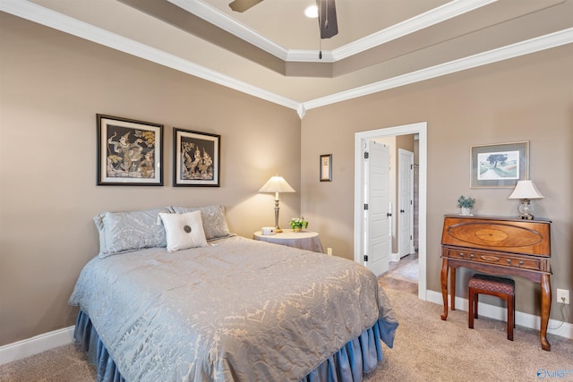 bedroom featuring ornamental molding, a tray ceiling, light colored carpet, and baseboards