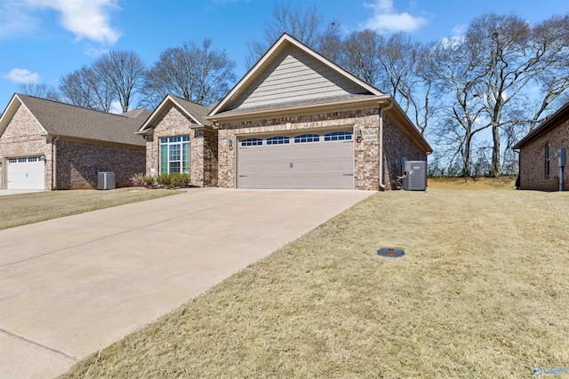 view of front of house with brick siding, central air condition unit, concrete driveway, a front yard, and a garage