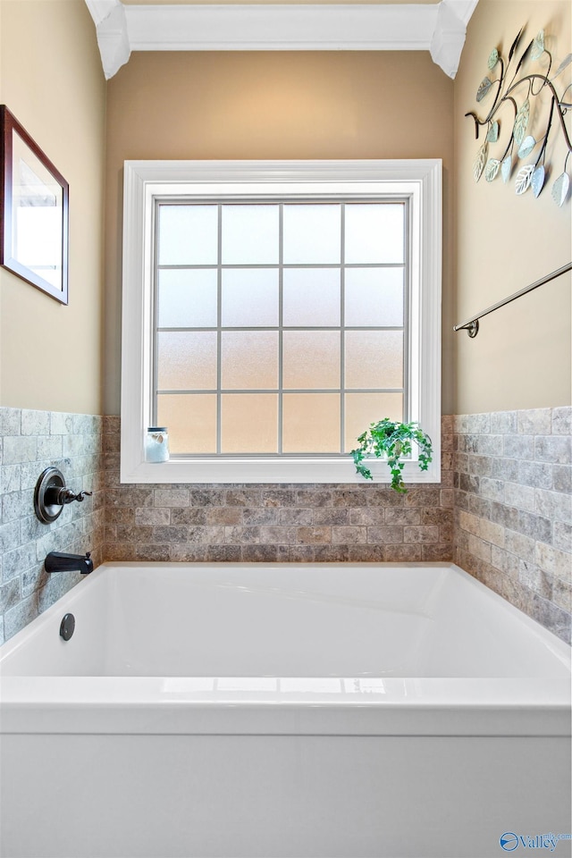 full bath with ornamental molding and a bath