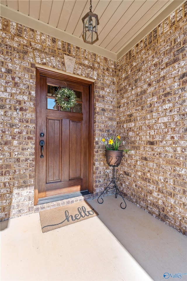 property entrance featuring brick siding