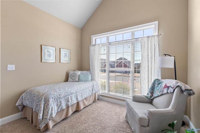 bedroom featuring light carpet, lofted ceiling, and baseboards