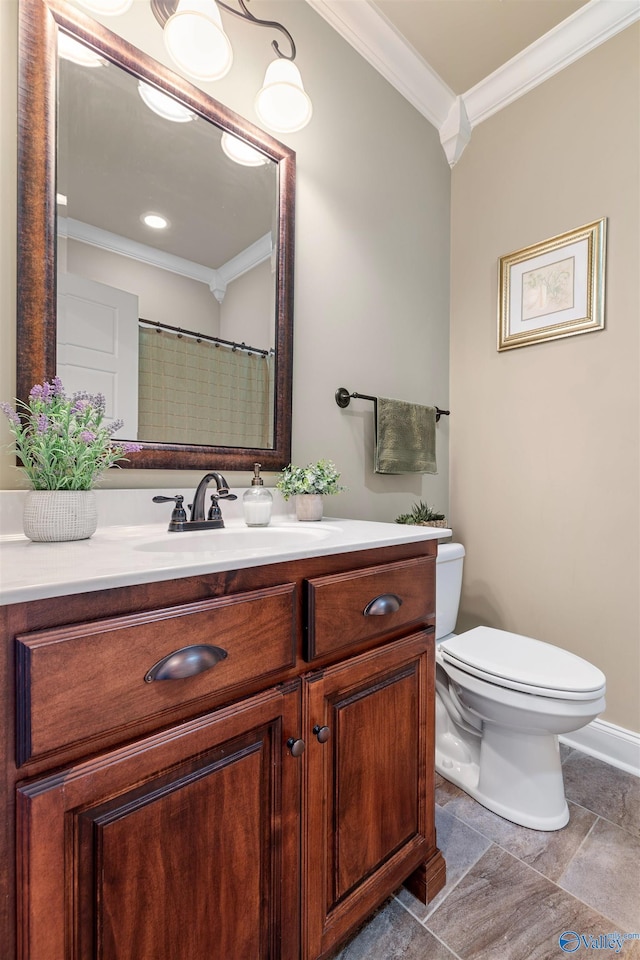 bathroom featuring crown molding, vanity, and toilet