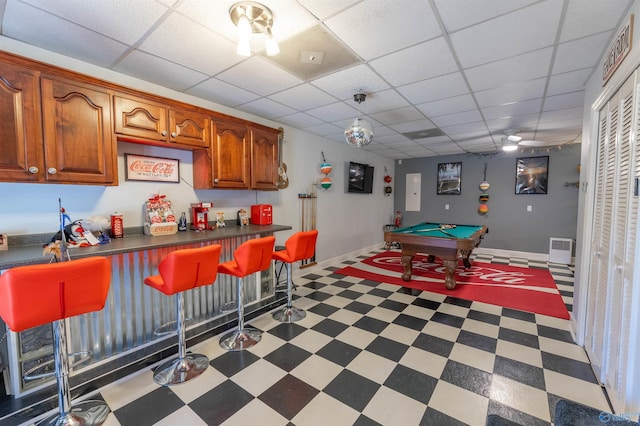 playroom with a dry bar, pool table, a drop ceiling, baseboards, and tile patterned floors