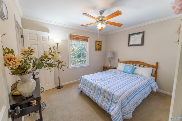 bedroom with light colored carpet, crown molding, and baseboards