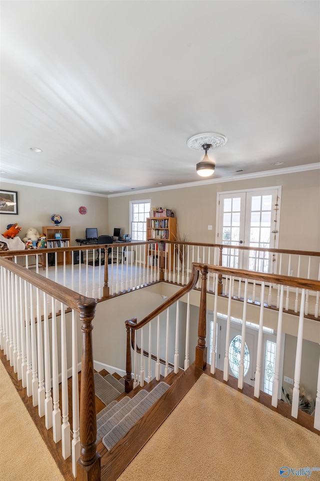 staircase with carpet floors, french doors, and crown molding