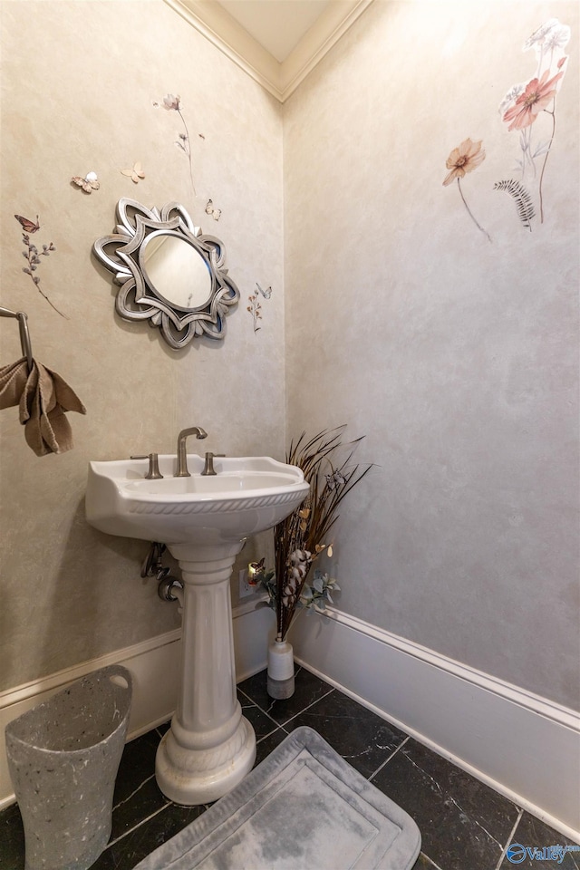 bathroom featuring baseboards and ornamental molding