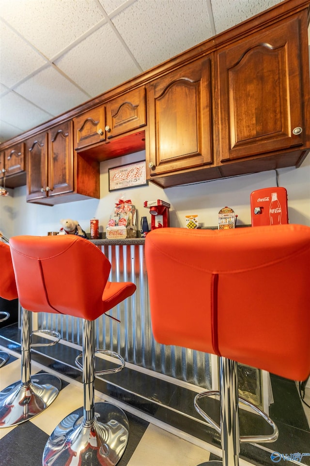 bar featuring a bar and a drop ceiling