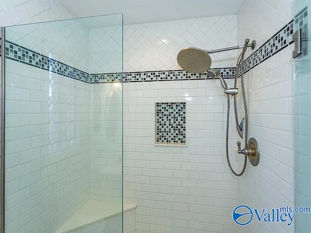 full bath featuring tiled shower