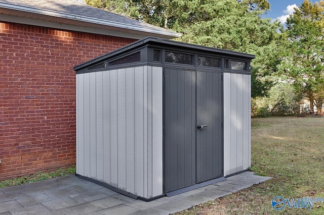 view of outbuilding with a lawn