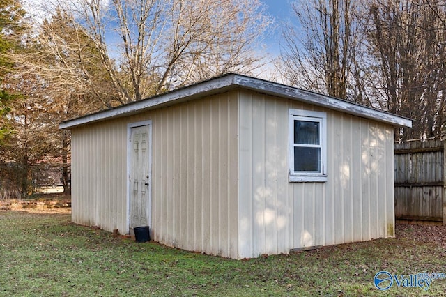 view of outbuilding with a lawn