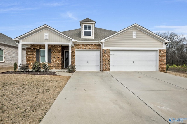 view of front of home featuring a garage, driveway, brick siding, and roof with shingles