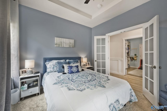 bedroom with a ceiling fan and french doors