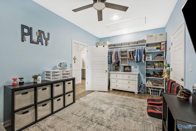 bedroom featuring ceiling fan, a closet, and wood finished floors