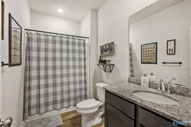 full bathroom with vanity, toilet, and wood finished floors