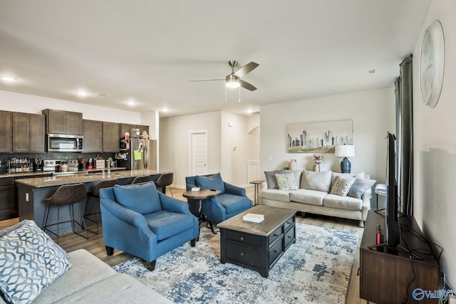 living area with light wood-style floors, recessed lighting, and a ceiling fan