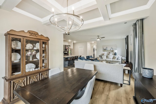 dining room with coffered ceiling, ornamental molding, beamed ceiling, light wood-style floors, and ceiling fan with notable chandelier