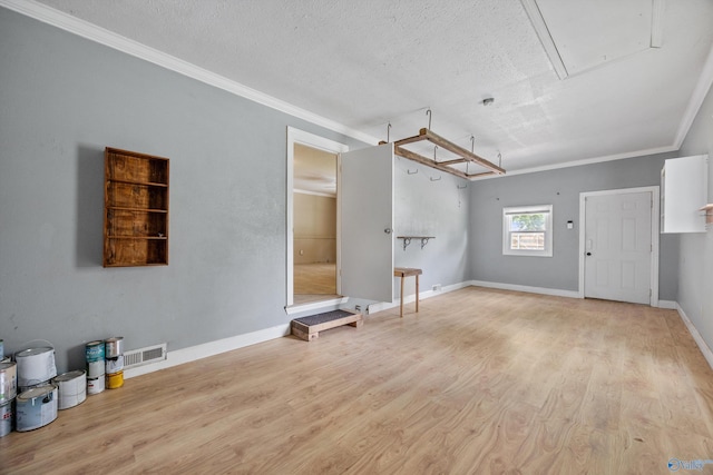 16712 Brooks Dr, Athens, AL 35611 - unfurnished living room featuring attic access, wood finished floors, crown molding, a textured ceiling, and baseboards