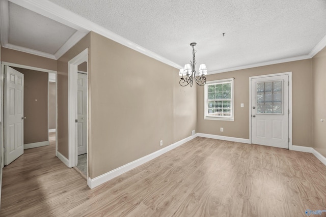 16712 Brooks Dr, Athens, AL 35611 - unfurnished dining area with light wood-style floors, a textured ceiling, a chandelier, crown molding, and baseboards