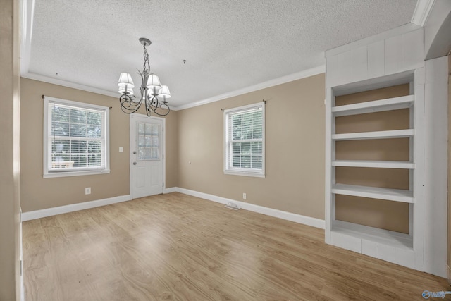 16712 Brooks Dr, Athens, AL 35611 - unfurnished dining area with a chandelier, a textured ceiling, light wood-style floors, ornamental molding, and baseboards