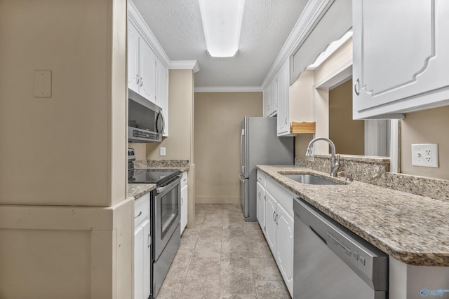 16712 Brooks Dr, Athens, AL 35611 - kitchen featuring stainless steel appliances, a sink, white cabinets, crown molding, and a textured ceiling