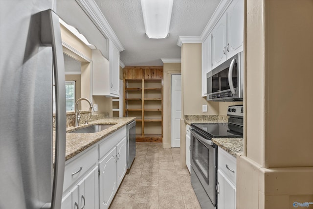 16712 Brooks Dr, Athens, AL 35611 - kitchen featuring appliances with stainless steel finishes, a sink, ornamental molding, white cabinets, and a textured ceiling