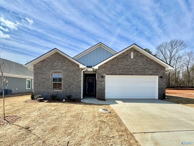 17812 Emma Jo Ln, Athens, AL 35611 - view of front facade with a garage, central AC, concrete driveway, and brick siding
