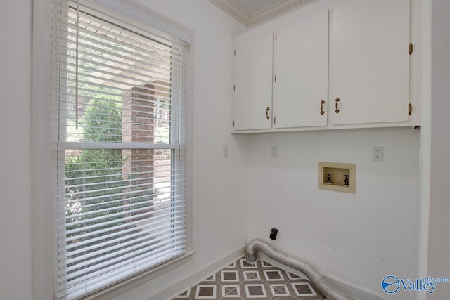 laundry room featuring cabinet space, washer hookup, ornamental molding, and baseboards