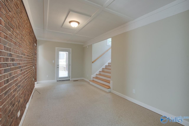 entryway featuring brick wall, stairway, light colored carpet, and baseboards