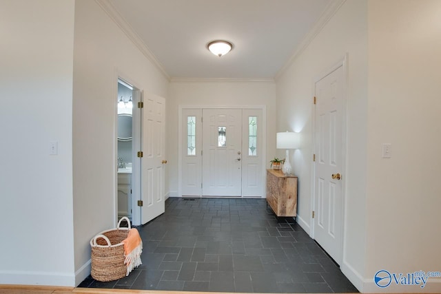 entryway featuring crown molding and baseboards