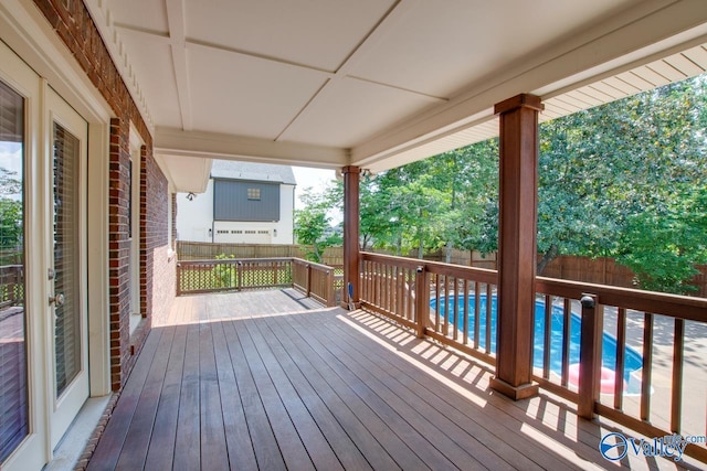 wooden deck with a fenced backyard