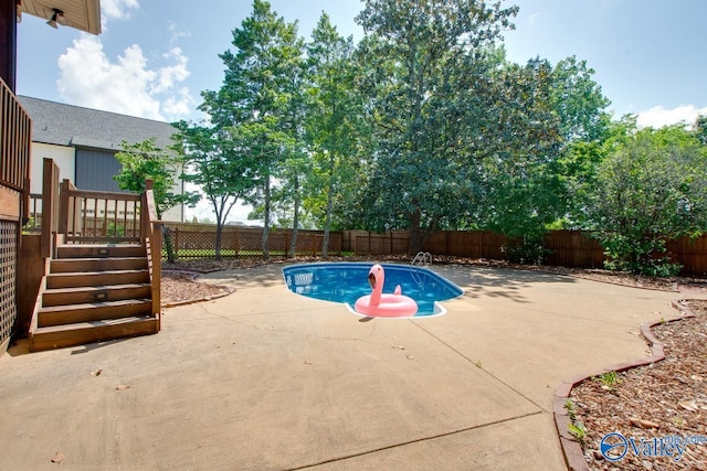 view of swimming pool with a fenced backyard and a patio