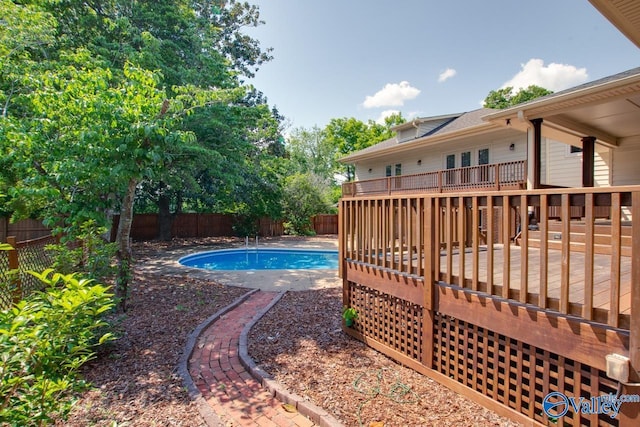 view of pool with a fenced backyard and a wooden deck