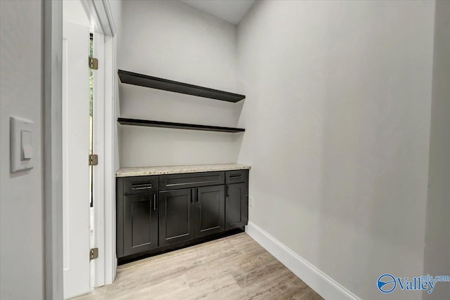 interior space with baseboards and wood finished floors