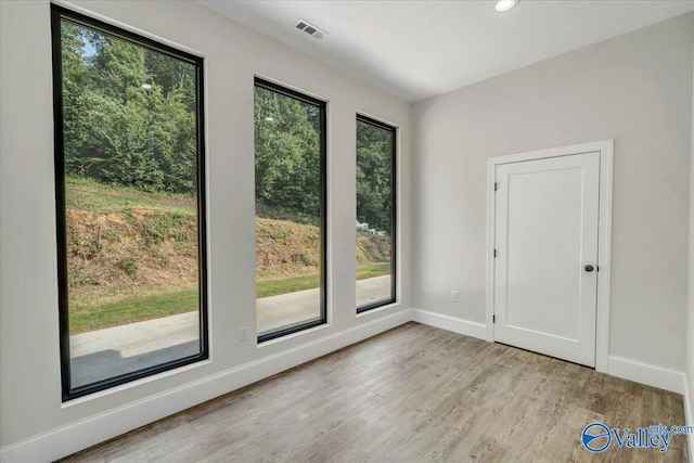 interior space featuring light wood-style floors, visible vents, baseboards, and recessed lighting